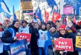 Striking nurses in Belfast holding RCN signs that say 'it's time to pay nursing staff fairly' and 'pay parity'